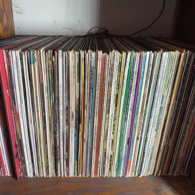 Sale Photo Thumbnail #120: Large shelf collection of vintage 33 RPM vinyl records, featuring various artists and genres.