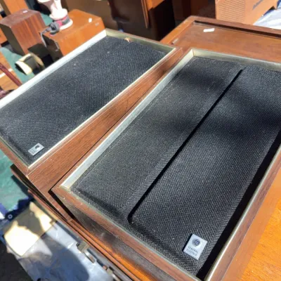 Sale Photo Thumbnail #77: Pair of vintage General Electric wood cabinet speakers with black fabric grilles, circa 1970s.