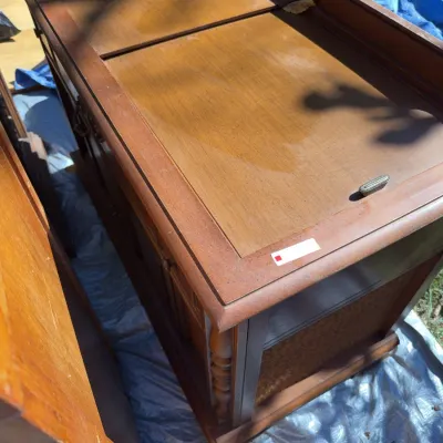 Sale Photo Thumbnail #78: Vintage mid-century wooden stereo console with sliding top panels and detailed cabinet carving.