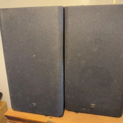 Sale Photo Thumbnail #155: Pair of General Electric bookshelf speakers with black fabric grilles and small logos on the front base.