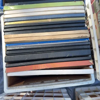 Sale Photo Thumbnail #29: Stack of vintage vinyl record box sets and albums stored vertically in a plastic crate.