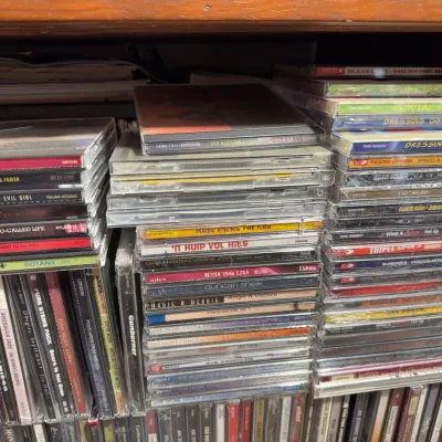 Sale Photo Thumbnail #127: Large collection of assorted audio CDs in jewel cases, featuring various artists and genres from the late 1990s and 2000s.