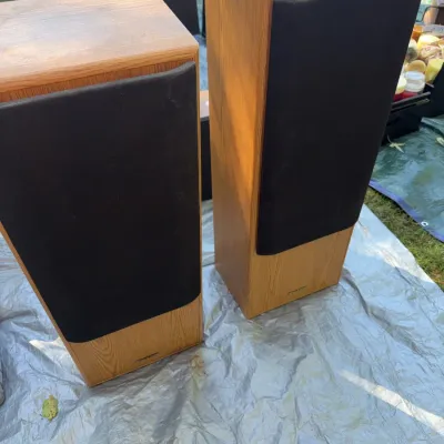 Sale Photo Thumbnail #44: Pair of vintage Sharp floor-standing speakers featuring light oak veneer cabinets and black fabric grilles.
