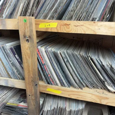 Sale Photo Thumbnail #88: Large collection of vintage vinyl LP record albums stored in wooden shelving units.