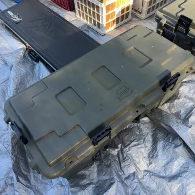 Sale Photo Thumbnail #2: Heavy-duty olive green Plano storage trunk with black latches, displayed alongside a Peavey hard guitar case and crates of vinyl records.
