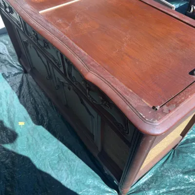 Sale Photo Thumbnail #61: Vintage wood stereo console with sliding top panels and decorative carved accents, showing light surface wear and finish scuffs.