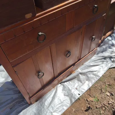 Sale Photo Thumbnail #76: Vintage mid-century wooden sideboard cabinet featuring metal ring pull handles, upper drawers, and lower cabinet doors, showing some surface wear.