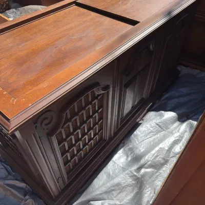 Sale Photo Thumbnail #75: Vintage wood stereo console cabinet featuring lattice-front speaker grills and a lift-top compartment, showing surface wear on the finish.