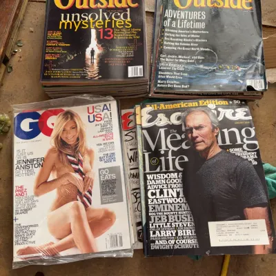 Sale Photo Thumbnail #143: Collection of men's lifestyle and outdoor magazines from the 2000s, including GQ featuring Jennifer Aniston and Esquire featuring Clint Eastwood.
