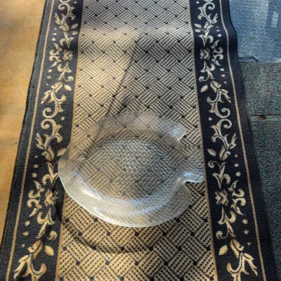 Sale Photo Thumbnail #96: Vintage clear textured glass fish-shaped serving platter resting on a floral-bordered patterned hallway runner.