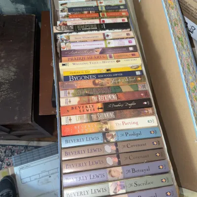 Sale Photo Thumbnail #180: Large collection of paperback Christian fiction and romance novels packed inside a long cardboard box, including numerous titles by Beverly Lewis.