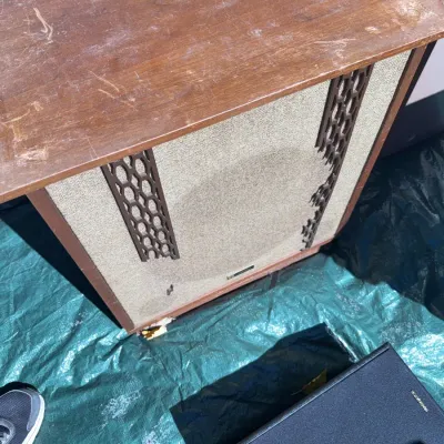 Sale Photo Thumbnail #55: Vintage mid-century floor speaker cabinet with wood veneer top and decorative plastic lattice trim over woven grille cloth.