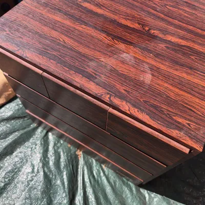 Sale Photo Thumbnail #69: Vintage rosewood veneer chest of drawers with a visible water ring mark on the top surface.