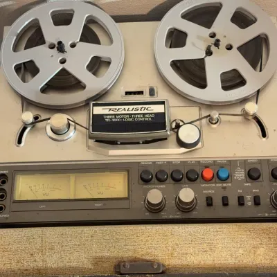 Sale Photo Thumbnail #151: Realistic TR-3000 reel-to-reel tape deck featuring three motors, three heads, logic control, dual analog VU meters, and metal spools.