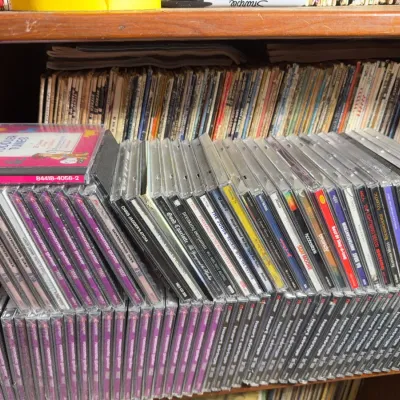Sale Photo Thumbnail #121: Large shelf collection of Compact Discs in jewel cases, featuring various pop, rock, and compilations from the 1990s and 2000s.