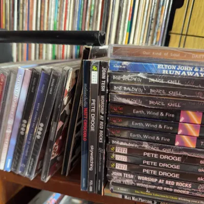 Sale Photo Thumbnail #124: Collection of music CDs in jewel cases, featuring titles by artists such as Earth, Wind & Fire, Pete Droge, and John Tesh.