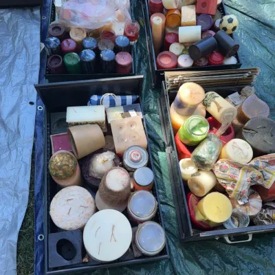 Sale Photo Thumbnail #47: Large assortment of decorative pillar, jar, and novelty candles in various shapes, sizes, and colors, displayed inside black storage drawers.