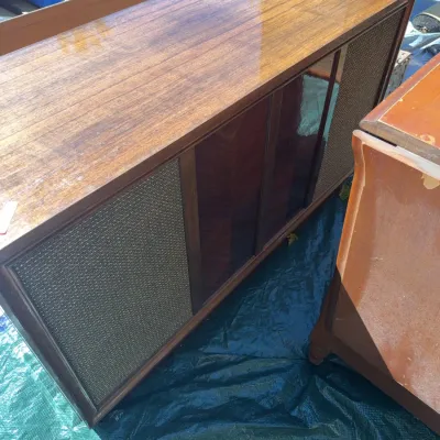 Sale Photo Thumbnail #66: Vintage mid-century wooden stereo console featuring woven fabric speaker grilles and a glossy finish.