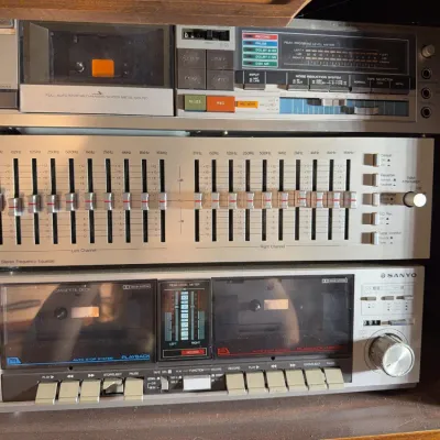 Sale Photo Thumbnail #166: Stack of vintage silver-face audio components, including an MCS Series 3035 graphic equalizer and a Sanyo dual cassette deck, circa 1980s.