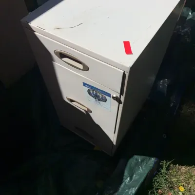 Sale Photo Thumbnail #53: Off-white metal two-drawer vertical filing cabinet showing minor surface wear and scratches.