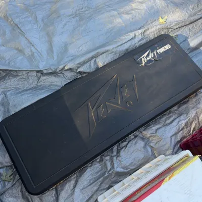 Sale Photo Thumbnail #4: Vintage Peavey hard shell guitar case in black molded plastic featuring the embossed Peavey logo and a Peavey Powered sticker.