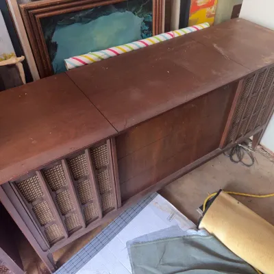 Sale Photo Thumbnail #184: Vintage mid-century wooden stereo console with woven speaker grilles and hinged top lids.