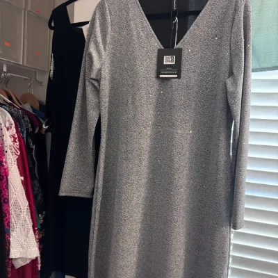 Sale Photo Thumbnail #151: New-with-tags JustFashionNow long-sleeved silver metallic glitter dress featuring a V-neckline.