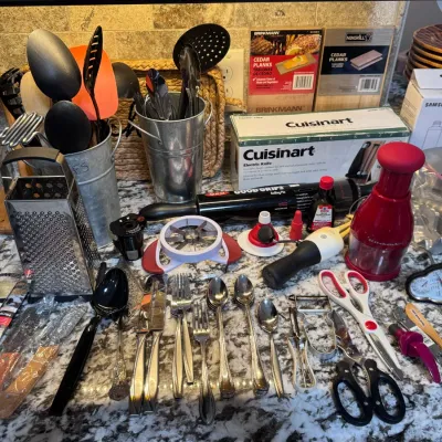 Sale Photo Thumbnail #120: Assorted modern kitchen utensils and small appliances, including Cuisinart electric knife, KitchenAid food chopper, cutlery, microplanes, and grilling planks.