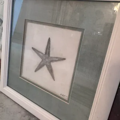 Sale Photo Thumbnail #112: Framed coastal art print of a starfish, signed Wyatt, featuring double matting and a square white wood frame.