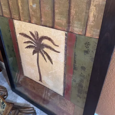 Sale Photo Thumbnail #119: Framed mixed-media art print featuring a central palm tree design with textured earth-tone panels and a dark wood frame.