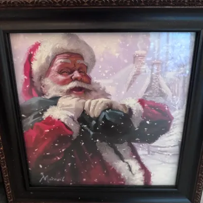 Sale Photo Thumbnail #110: Framed Santa Claus print signed by artist Richard Macneil, featuring glitter accents and a dark molded frame.
