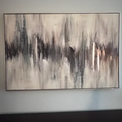 Large contemporary abstract canvas painting featuring neutral tones of grey, white, and black with metallic accents in a thin frame.