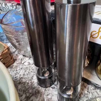 Sale Photo Thumbnail #125: Pair of modern stainless steel electric salt and pepper grinders with clear acrylic viewing windows, presented in very good condition.