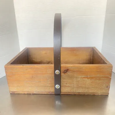 Sale Photo Thumbnail #12: Rustic wooden caddy basket with a dark metal fixed overhead handle.