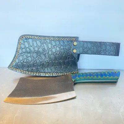 Sale Photo Thumbnail #50: Custom heavy-duty meat cleaver with a textured file-metal blade, a blue and green laminate handle, and a black embossed leather sheath.