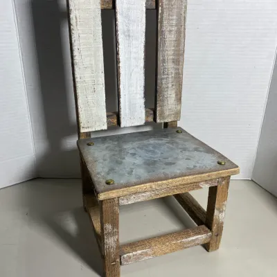 Sale Photo Thumbnail #109: Rustic miniature chair crafted from weathered pallet wood with a galvanized metal seat panel and brass accents.