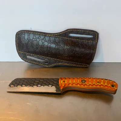 Sale Photo Thumbnail #77: Custom fixed-blade cleaver-style knife with textured spine, colorful patterned G10 handle, and custom brown leather belt sheath.