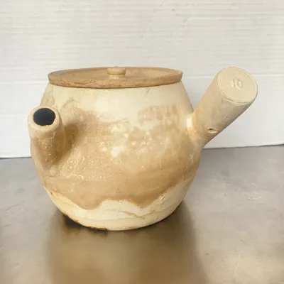 Sale Photo Thumbnail #10: Vintage unglazed earthenware kyusu teapot with a side handle and lid, featuring natural clay variation and a stamped number 10 on the handle end.