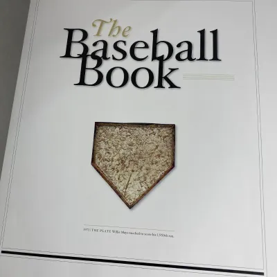 Sale Photo Thumbnail #106: Front cover of "The Baseball Book" oversized coffee table book featuring an image of a 1971 home plate touched by Willie Mays.