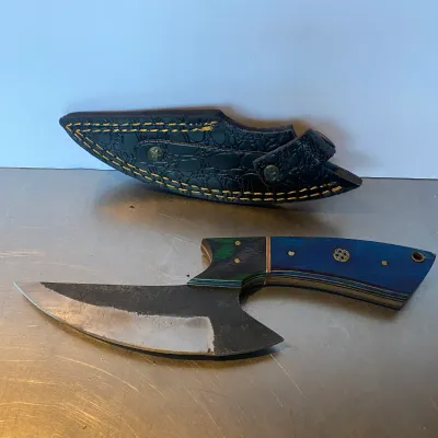 Sale Photo Thumbnail #88: Custom fixed-blade skinner knife featuring a curved steel blade, colorful laminated wood handle with mosaic pins, paired with a fitted black leather sheath.