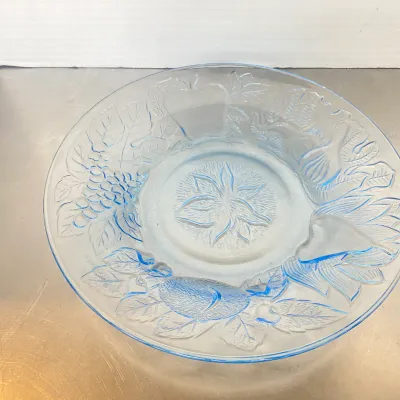 Sale Photo Thumbnail #24: Vintage light blue glass platter featuring embossed fruit and floral motifs along the rim and center.