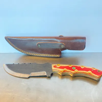 Sale Photo Thumbnail #83: Custom file knife featuring a textured steel blade, colorful layered wood handle scales, and decorative mosaic pins, accompanied by a fitted brown leather sheath.