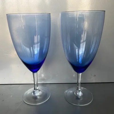 Sale Photo Thumbnail #40: Pair of modern blue gradient glassware wine goblets with clear stems and circular bases.