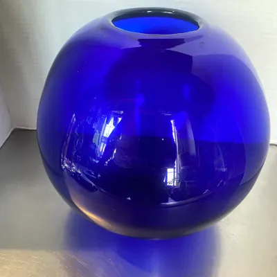 Sale Photo Thumbnail #5: Large round cobalt blue glass sphere vase featuring a smooth, reflective surface and a top opening.