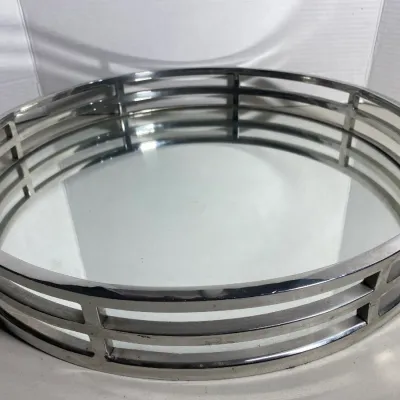 Sale Photo Thumbnail #110: Contemporary round vanity tray featuring a reflective mirrored base encased in a polished chrome slotted metal frame.