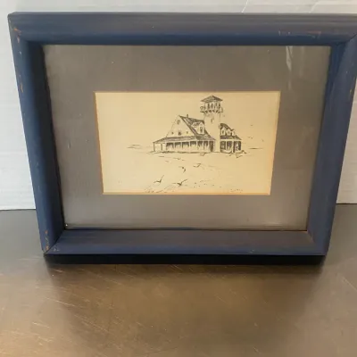 Sale Photo Thumbnail #21: Framed ink drawing of a coastal lighthouse building, housed in a double mat and a painted blue wooden frame with light distress.