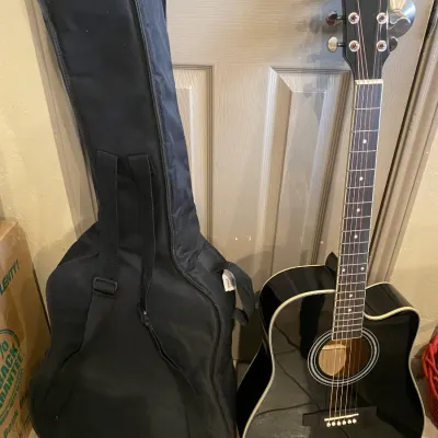 Sale Photo Thumbnail #118: Black Best Choice Products acoustic-electric cutaway guitar, accompanied by a soft padded gig bag.