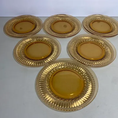 Sale Photo Thumbnail #27: Set of six amber depression glass salad or dessert plates featuring a ribbed wide rim design.