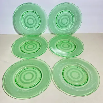 Sale Photo Thumbnail #30: Set of six vintage green depression glass plates featuring a concentric ring pattern.