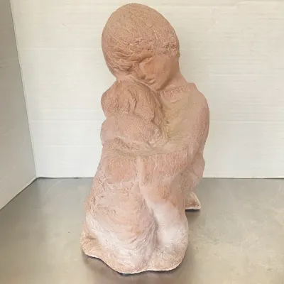 Sale Photo Thumbnail #4: Terracotta or composition sculpture depicting a young child embracing a dog, featuring a textured matte finish.